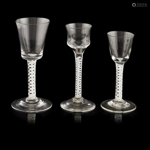 THREE GEORGIAN OPAQUE TWIST STEM WINE GLASSESMID-18TH CENTURY all raised on double series opaque