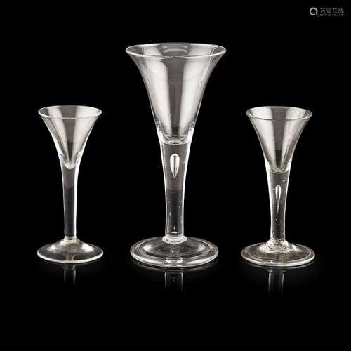 GROUP OF THREE GEORGIAN WINE GLASSESMID-18TH CENTURY each with plain flared trumpet-form bowls,