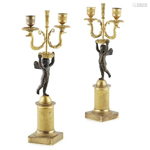 PAIR OF FRENCH EMPIRE GILT AND PATINATED BRONZE CANDELABRAEARLY 19TH CENTURY modelled as putti