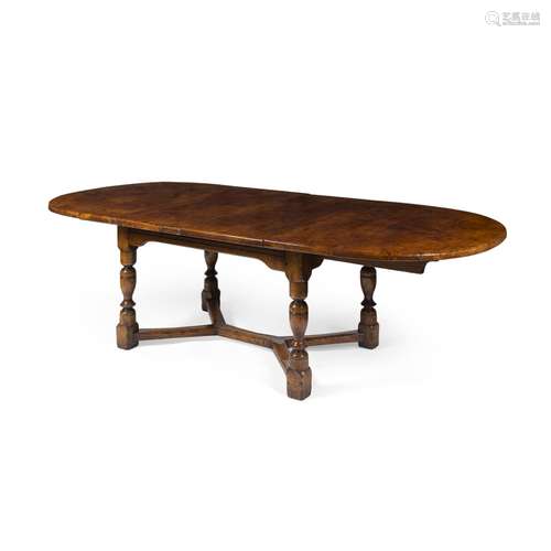 OAK AND BURR OAK DRAW LEAF DINING TABLEEARLY 20TH CENTURY the oval top with two leaf inserts,