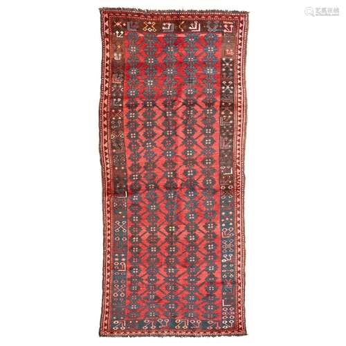 KYRGYZ RUNNERKYRGYZSTAN, LATE 19TH/EARLY 20TH CENTURY the red field with allover indigo flowerhead