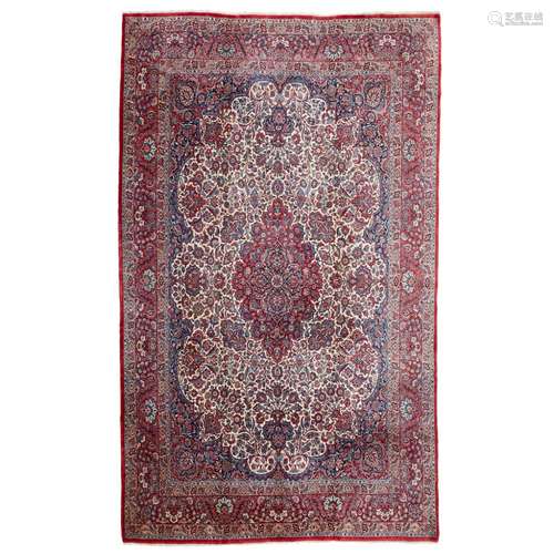 KASHAN CARPETCENTRAL PERSIA, EARLY 20TH CENTURY the cream field with red and indigo medallion,