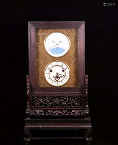 AN OLD RED WOOD MECHANICAL CLOCK