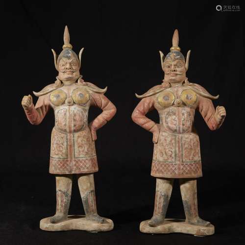 A pair of Chinese painted and parcel gilt pottery figures of warriors
