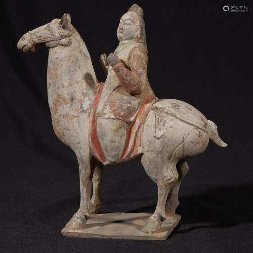 A Chinese painted grey pottery horse and rider