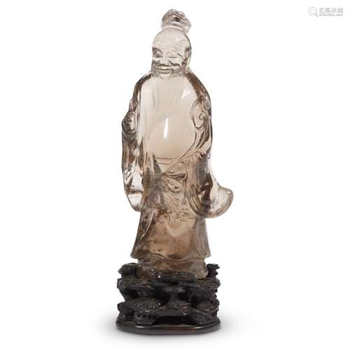 A Chinese carved smokey quartz figure of an immortal on carved hardwood stand