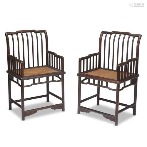 A pair of Chinese hardwood spindle-back armchairs