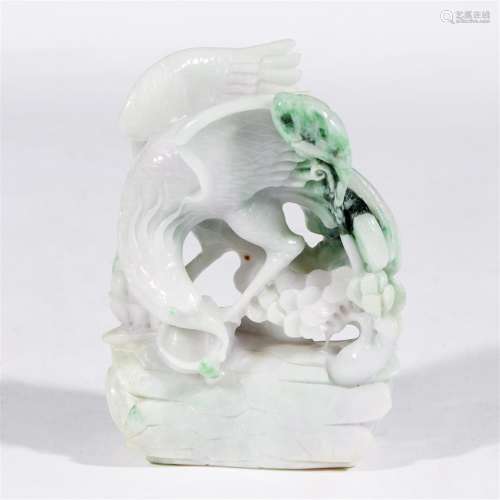 A carved white and green jadeite model of an eagle on pine log