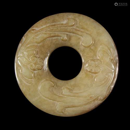 A Chinese archaistic carved celadon and russet jade small bi-disk