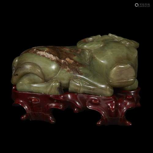 A Chinese celadon and brown jade carving of a recumbant water buffalo