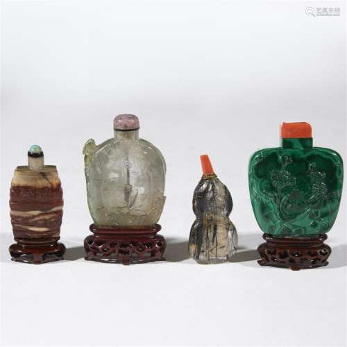 A group of four Chinese carved hardstone snuff bottles