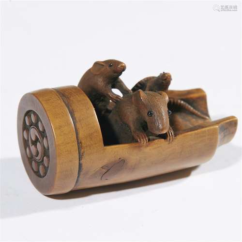 A Japanese carved boxwood netsuke depicting three rats on a roof tile, Ryumin