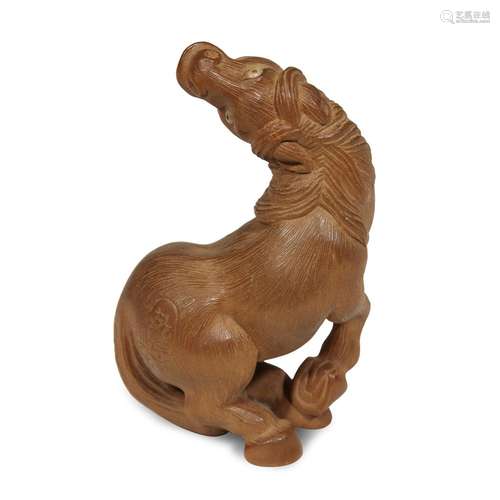 A Japanese carved boxwood netsuke of a seated horse with raised head, Bishu (Katsutoshi Saito)