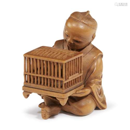 A Japanese carved boxwood netsuke of a boy and birdcage, So school