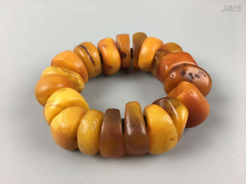 A STRING OF OLD BEESWAX BEADS