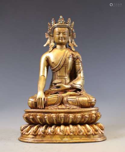 A GILT BRONZE FIGURE OF SEATED CROWNED BUDDHA