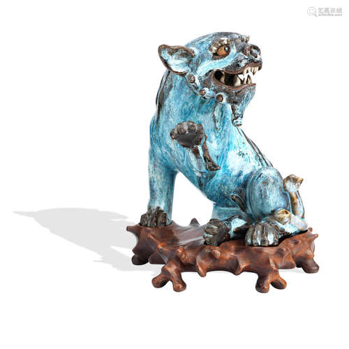 Late 19th century A Shiwan lion dog on wood stand