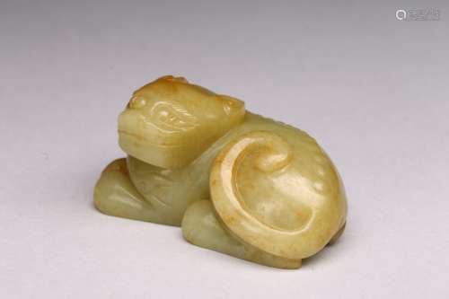 A YELLOW JADE CARVED RECUMBENT MYTHICAL BEAST