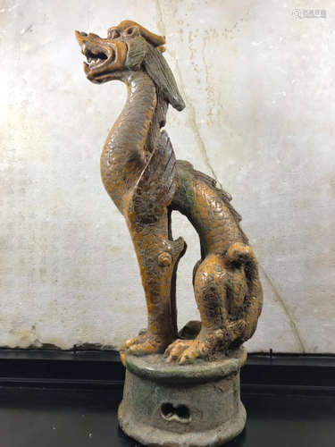 A DRAGON SHAPED PORCELAIN FIGURE