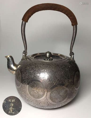 A SILVER MOLDED HANDLE WATER POT