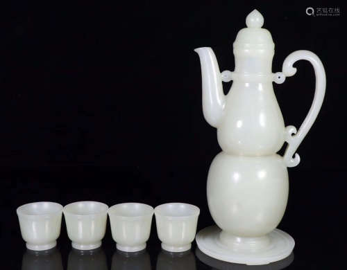 A HETIAN JADE CARVED TEAPOT AND CUPS