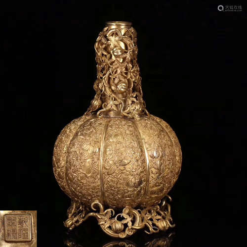 A MELON SHAPED GILT COPPER CANDLE HOLDER