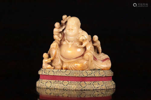 A SOAPSTONE CARVED LAUGHING BUDDHA FIGURE