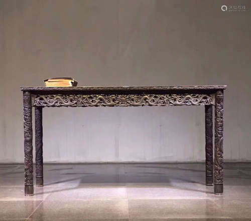 A TAN WOOD CARVED DRAGON PATTERN TABLE