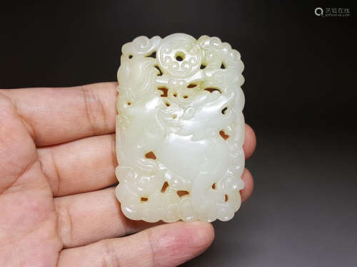 A HETIAN JADE CARVED HOLLOW BEAST PATTERN PAI