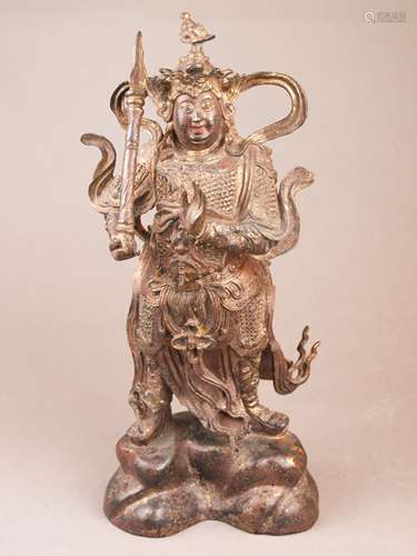 Bronze figure of the god Er-lang Shen - China, bronze with gold lacquer, in a standing<br />position on a high vaulted rock base, in full armor, with waving ribbons and a helmet, the third eye as a prominent decorative ornament on the helmet, height: ca.39cm , lacquer with signs of age