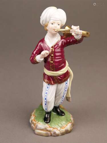 Musician from ''The Turkish Orchestra''- Hoechst, Germany, blue wheel mark with painter's<br />mark 'Tö 381', 20th century, French horn player, porcelain, glazed, polychrome painted, gold decor, red jacket, white trousers with blue pattern, black boots and white turban, on naturalistic base, designed by Johann Peter Melchior (1747-1825), H.ca.18cm