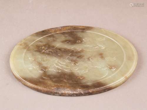 Large oval jade plaque - celadon-green jade with brown color inclusions, five shishis<br />playing with brocade ball, surrounded by a meandering border, inscription in chinese calligraphy, ca.18x14cm, ca.495g, minimal bumps, edges slightly uneven