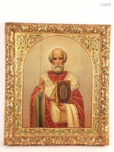 Icon - Russia around 1890, egg tempera on chalk ground, St. Nicholas the Wonderworker as<br />half figure in frontal representation, his right hand is raised in the blessing gesture, in his left he holds the closed Gospels book, whose cover is decorated with ornate golden fittings, the saint wears red phelonium with lush chrysography and omophorion with large crosses as decoration, hallmarked gold-ground framing decorated with leafy tendrils and pearl edge in polychrome enamel painting, some slight enamel damages, made of three wooden boards with two backside cross bars, middle board formerly cracked and restored , partially small damages and chippings, approx. 44x37cm, in vaulted gold framing with reliefed acanthus leaves, ca.51x44,5, slight abrasion, upper left corner with eruption, stucco layer partly chipped