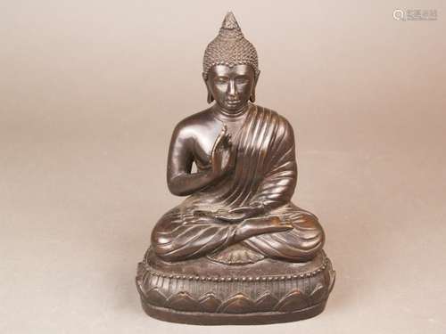 Seated Buddha - bronze, Buddha resting in a diamond seat on a simple lotus base, the right<br />hand in vitarka-mudra, the left lying open in the lap, small knobbed curls cover head with flambeau ushnisha, open filled bottom, Sukhothai style, Thailand, H.ca .21.5 cm