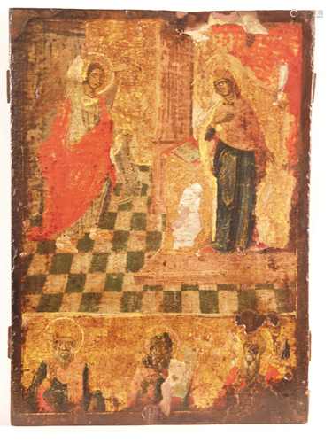 Two field icon - Greece early 17th century, egg tempera on chalk and gold ground, picture<br />field bisected: the upper part shows the Annunciation of the Virgin Mary; the Archangel Gabriel steps with his arm up from the left edge towards the Blessed Mother, who stands at the lectern with one hand resting on her breast, three bearded saints are depicted at the bottom, single panel with two nailed backside crossbars, ca.40,5x29 ,5cm, layers of painting damaged: bumps, missing parts, larger paint abrasion in places