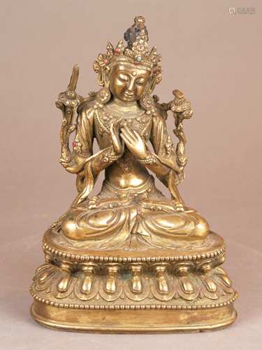 Manjushri Bodhisattva - sino-tibetan, c. 1900, glt copper set with stones, remains of<br />cultic paint, the richly bejewelled  Manjushri sits in dhyana-asana on a double lotus throne wearing the five-pointed crown of a bodhisattva. The 'sword of knowledge' and the 'book of transcendent wisdom' (= Indian palm-leaf manuscript) resting on the lotus blossoms growing up beside his shoulders. Holding the long lotus stems, the patron of scholars simultaneously performs the Dharmachakra mudra, bottom plate with a double vajra motif loosely inserted, some stones missing, one lotus stem restored, crooked, H.c.24cm