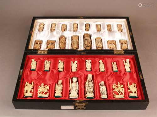 Chess game - China, 32 carved ivory figures, half of the figures is slightly colored,<br />decorated in engraving technique, partially black pigmented, box / board with white silk insert, 2  figure sets in the form of a fictional imperial court and soldiers, King (= Emperor) H.ca.10cm, box opened ca.45,5x45,5x5,5cm This item is made of materials that require CITES certificate when exporting to countries outside the EU.