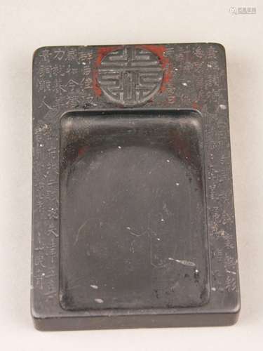 Inkstone - China, rectangular shape ca.13,5x9x2cm, black stone, Chinese characters carved<br />and in relief, slight signs of usage