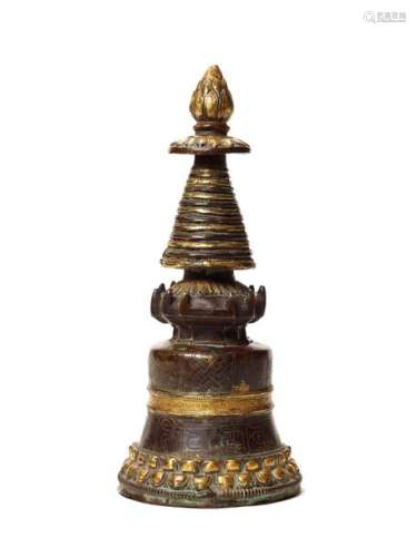 A GILT BRONZE TIBETAN VOTIVE STUPA