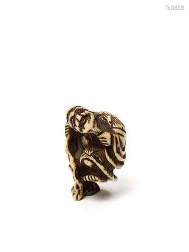 A STAGHORN NETSUKE OF TEKKAI SENNIN, 19TH CENTURY