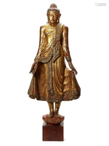 A BURMESE MANDALAY STYLE LACQUER GILT WOOD FIGURE OF A …