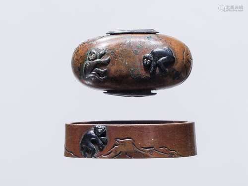 A COPPER FUCHI KASHIRA INLAID WITH SHAKUDO MONKEYS