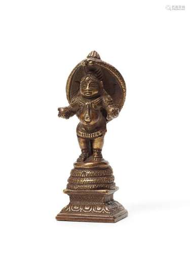 A RARE INDIAN BRONZE OF STANDING KRISHNA WITH NAGA