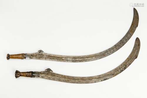 A PAIR OF SOUTH-EAST ASIAN CURVED AND ENGRAVED SWORDS