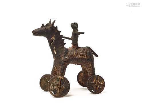 A RARE KONDH TRIBAL BRONZE OF A WARRIOR ON A HORSE WITH WHEELS