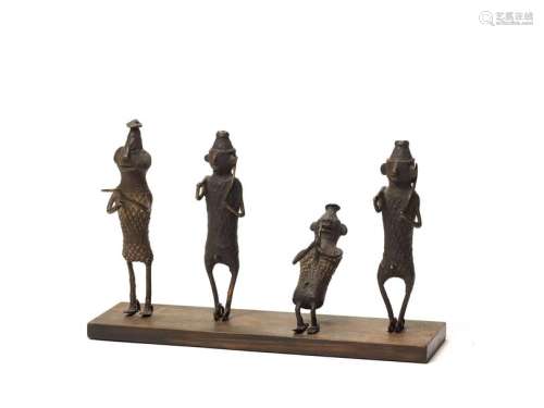 A RARE GROUP OF FOUR KONDH TRIBAL BRONZES MOUNTED ON A WOOD BASE