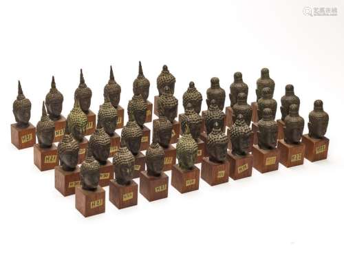 A LARGE AND VERY RARE LOT OF 33 BRONZE BUDDHA HEADS, AYUTTHAYA KINGDOM