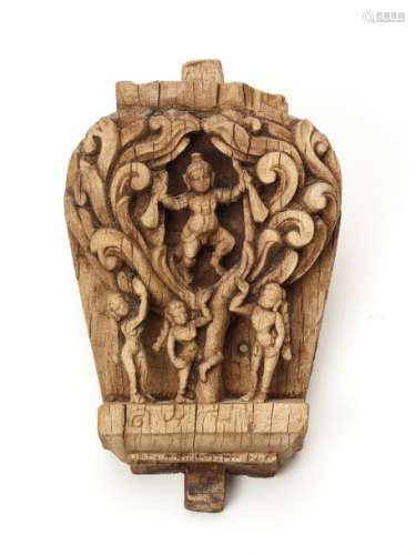A FINE WOOD CARVING OF DANCING KRISHNA INSIDE THE BODHI TREE WITH WORSHIPPERS