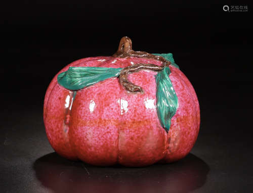 A RED GLAZED PUMPKIN SHAPED ORNAMENT