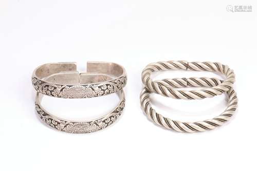 Two Pair of Carved Silver Bracelets